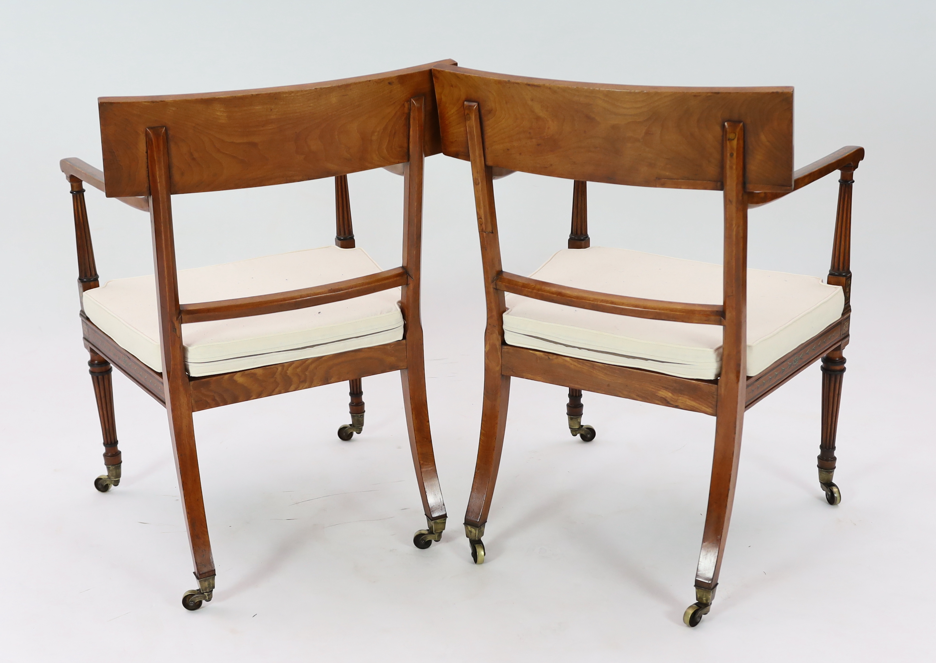 A pair of Edwardian Sheraton revival painted satinwood elbow chairs, 58cm wide, 57cm deep, 88cm high